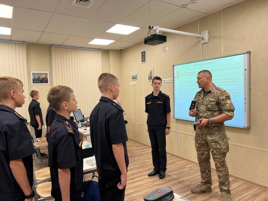 The Code of Honor of a Russian Officer book being handed out to Russia’s  Sevastopol Cadet Corps by DPR adviser Yan Gagin. (Source: Black 100)