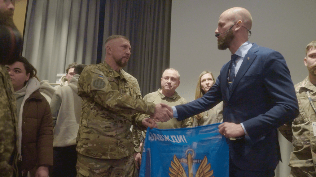 Carl-Oskar Bohlin is presented with a flag from Ukraine’s 37th Marine Brigade at the Repower psychological recovery project. Stockholm County, Sweden, January 28, 2026 (Photo: Mykola Hrinenko/UNITED24 Media)