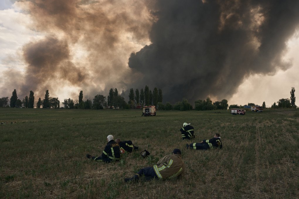State Emergency Service rescue workers stand dispersed across a field, waiting for the air raid alert to end before safely resuming operations to extinguish a massive fire at a commercial warehouse following a Russian drone strike on August 27, 2026 in Boryspil, Kyiv region, Ukraine. (Photo by Kostiantyn Liberov via Getty Images) State Emergency Service rescue workers stand dispersed across a field, waiting for the air raid alert to end before safely resuming operations to extinguish a massive fire at a commercial warehouse following a Russian drone strike on August 27, 2026 in Boryspil, Kyiv region, Ukraine. (Photo by Kostiantyn Liberov via Getty Images)