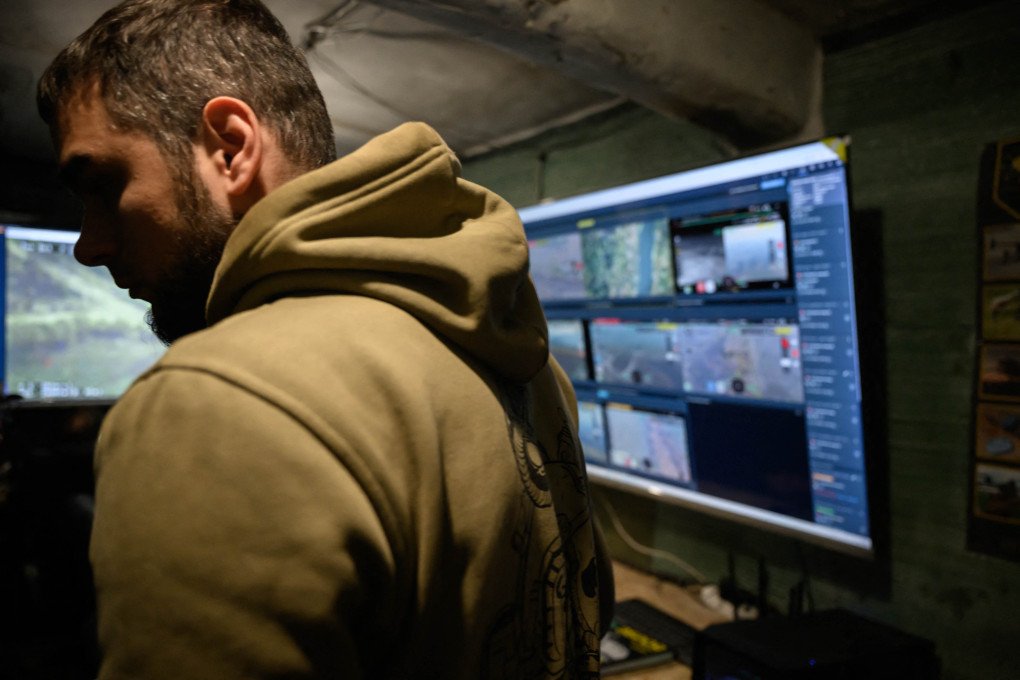 A screen shows Ukrainian soldiers watching a fatal drone strike. (Photo: Ed Jones via Getty Images)