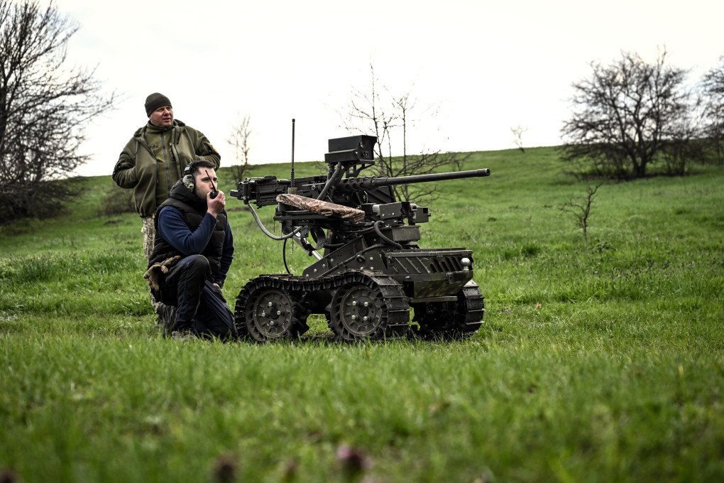 Press officer of the 65th Mechanised Brigade "Velykyi Luh" Serhii Skibchyk and design engineer Denys (L to R) stay by a ground robotic complex during trials at a training ground, April 10, 2026. (Photo by Dmytro Smolienko via Getty Images) Press officer of the 65th Mechanised Brigade "Velykyi Luh" Serhii Skibchyk and design engineer Denys (L to R) stay by a ground robotic complex during trials at a training ground, April 10, 2026. (Photo by Dmytro Smolienko via Getty Images)