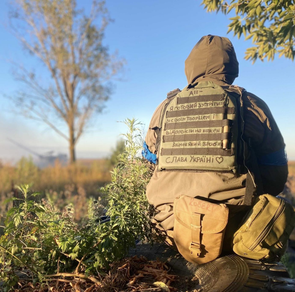 Conor Kennedy sits in full gear with a handwritten Ukrainian inscription on his plate carrier during his service in Ukraine. (Source: Instagram / Conor Kennedy) Conor Kennedy sits in full gear with a handwritten Ukrainian inscription on his plate carrier during his service in Ukraine. (Source: Instagram / Conor Kennedy)