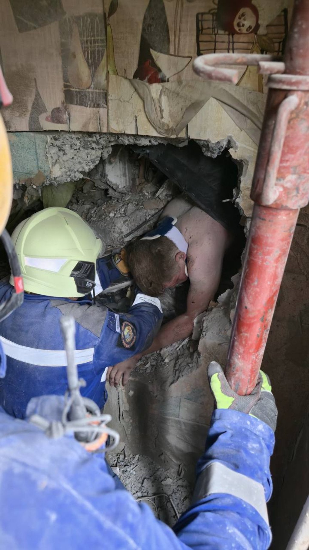 Rescuers working to get the stuck man out of the rubble of the collapsed building, July 31, 2025. (Source: SES)