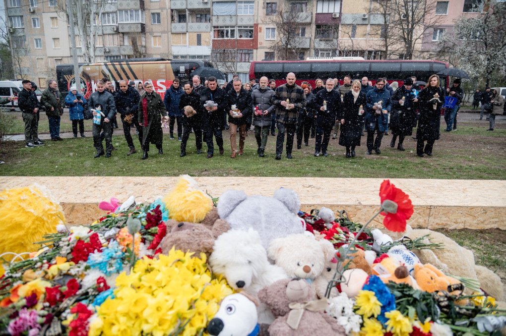 APRIL 9, 2025: Foreign diplomats gather at a makeshift memorial on a playground in Kryvyi Rih, Ukraine, to honor the victims of Russia’s missile strike. (Photo: Eduard Kryzhanivsky via Getty Images)