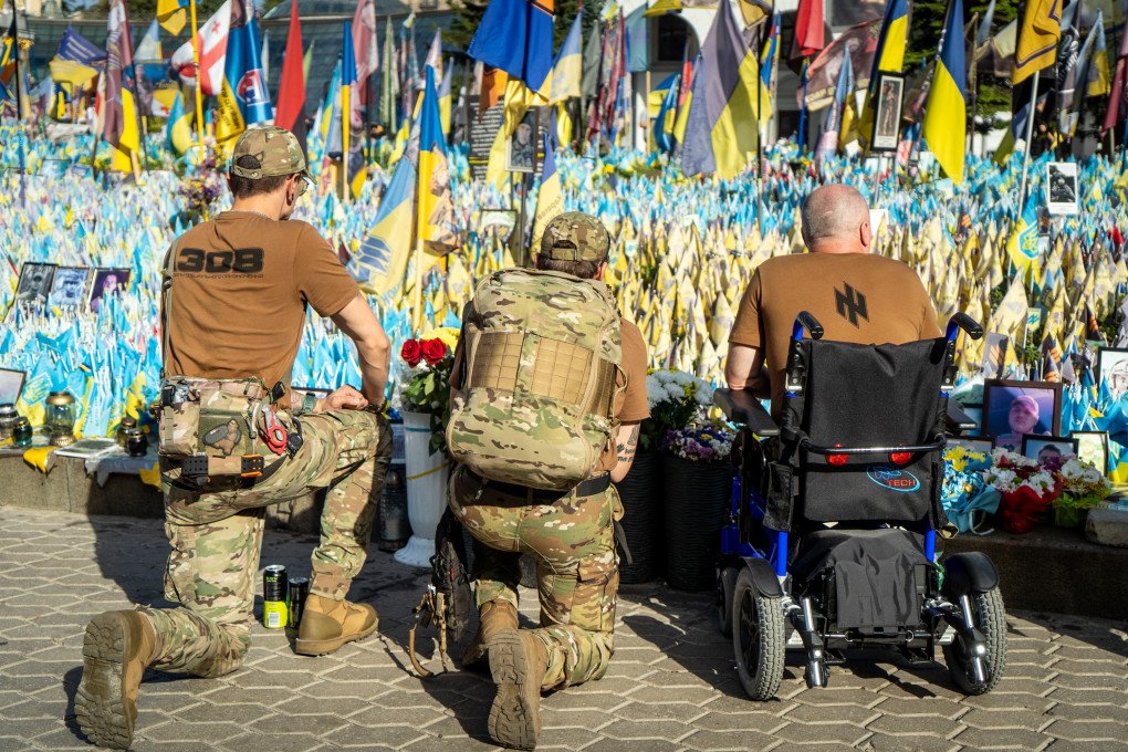 Soldiers of Azov brigade near makeshift memorial to fallen defenders of Ukraine