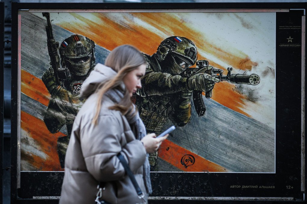 A woman walks past a poster depicting Russian servicemen at an exhibition dedicated to the so-called “special military operation” in Ukraine on Bolshaya Morskaya Street in St. Petersburg. (Photo by Artem Priakhin via Getty Images) A woman walks past a poster depicting Russian servicemen at an exhibition dedicated to the so-called “special military operation” in Ukraine on Bolshaya Morskaya Street in St. Petersburg. (Photo by Artem Priakhin via Getty Images)