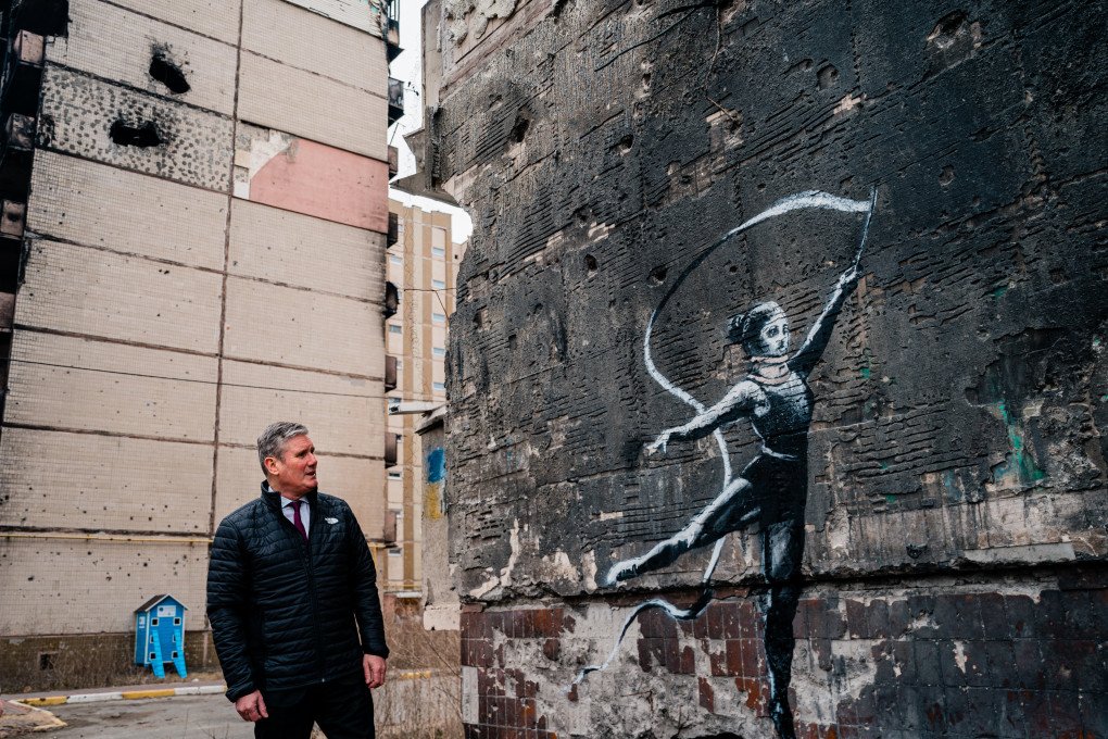 Starmer looks at an art piece by British artist Banksy on a wall of a residential building in the town of Irpin, on February 16, 2023. Source: Getty Images Starmer looks at an art piece by British artist Banksy on a wall of a residential building in the town of Irpin, on February 16, 2023. Source: Getty Images