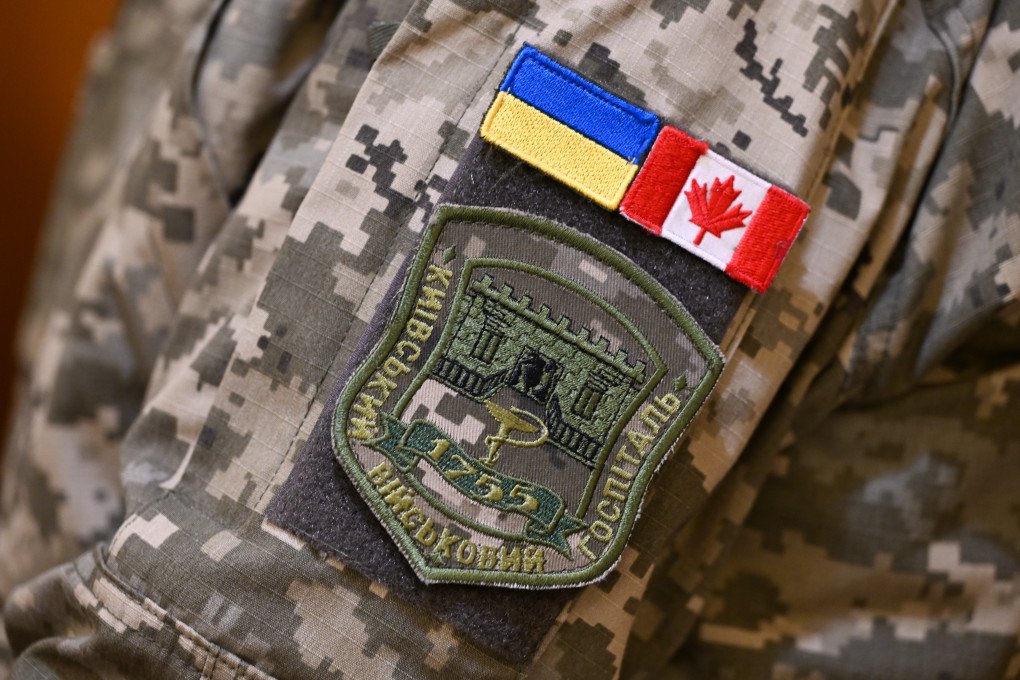 A volunteer in military uniform displays Ukrainian and Canadian small flag patches, along with a Kiyv Military Hospital patch, as hundreds of members of the Ukrainian diaspora and supporters gather for a multi-denominational prayer service honoring Ukrainian defenders and victims of the war, marking the third anniversary of Russia-Ukraine war, in Edmonton, Alberta, Canada on February 24, 2025. (Photo by Artur Widak via Getty Images) A volunteer in military uniform displays Ukrainian and Canadian small flag patches, along with a Kiyv Military Hospital patch, as hundreds of members of the Ukrainian diaspora and supporters gather for a multi-denominational prayer service honoring Ukrainian defenders and victims of the war, marking the third anniversary of Russia-Ukraine war, in Edmonton, Alberta, Canada on February 24, 2025. (Photo by Artur Widak via Getty Images)