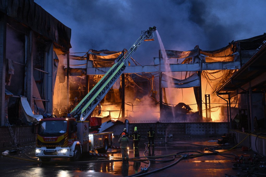 Firefighters extinguish a blaze at a food warehouse after a Russian missile strike in Kyiv on October 25, 2025. (Source: Getty Images)