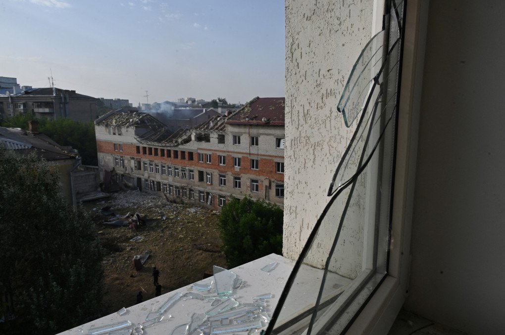 This photograph shows an unfinished residential building damaged after a drone attack, visible from a maternity hospital room after the strike, in central Kharkiv on July 11, 2025. (Source: Getty Images)