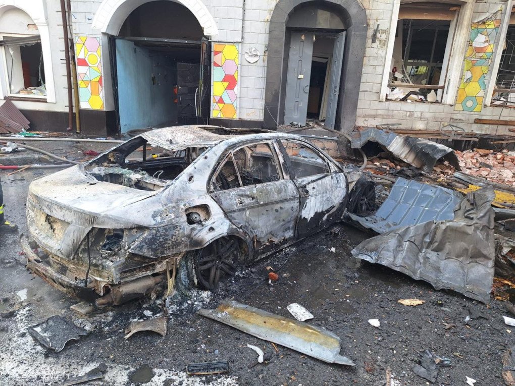 Burned-out cars lie outside the kindergarten as firefighters continue to extinguish the fire caused by the explosion. (Source: SBU)