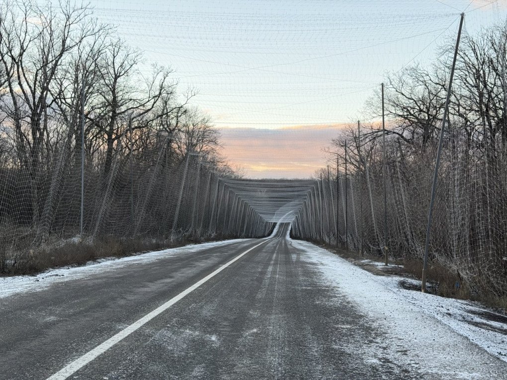 Anti-drone nets stretch across a Ukrainian road. Photo: ILLIA KABACHYNSKYI / UNITED24 Media