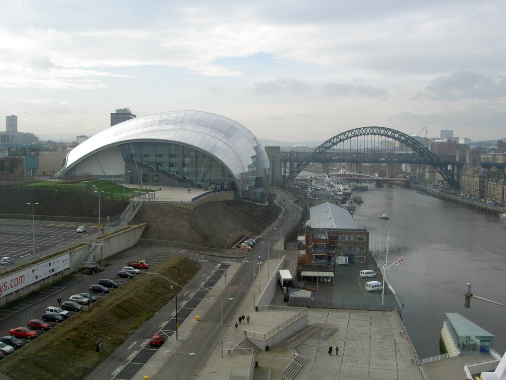 HMS Calliope (center, small building on the riverbank), 2005. (Source: Wikimedia)