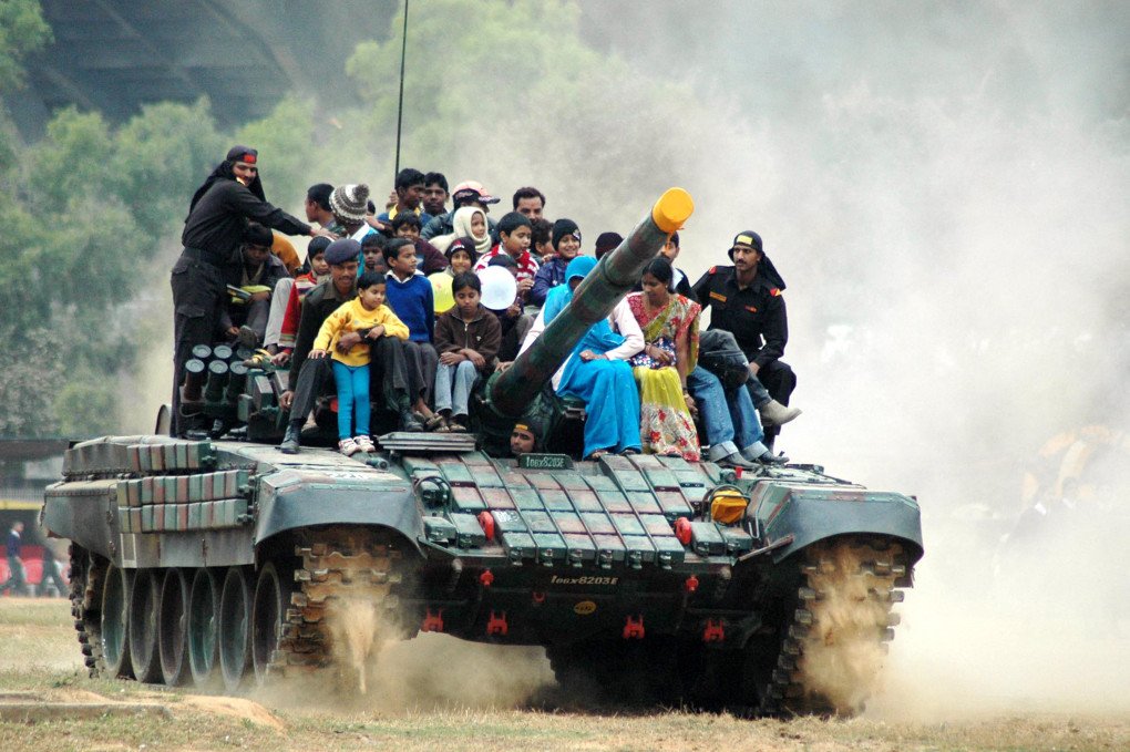Civilians take a joy ride on top of an Indian Army T-72 Ajeya battle tank during the 'Know You Army' public exhibition event at Morhabadi Ground in Ranchi on January 6, 2009. (Source: Getty Images)