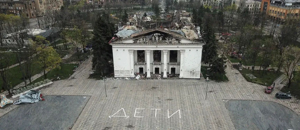 Aerial view of the destroyed Mariupol Drama Theater, with the word “ДЕТИ” (“children”) still visible on the pavement. The building was bombed by Russian forces on March 16, 2022, despite serving as a civilian shelter. (Photo: open source) Aerial view of the destroyed Mariupol Drama Theater, with the word “ДЕТИ” (“children”) still visible on the pavement. The building was bombed by Russian forces on March 16, 2022, despite serving as a civilian shelter. (Photo: open source)
