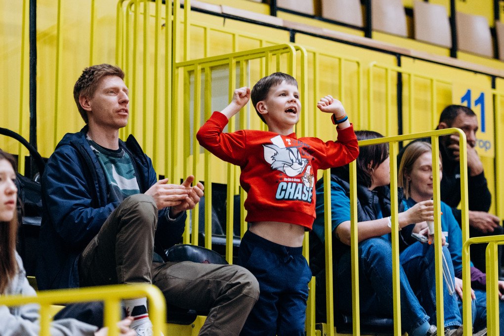 A young fan jumps to his feet, cheering on the players with infectious excitement during the All-Ukrainian Wheelchair Basketball Tournament for veterans. Photo: Serhii Halushka, Come Back Alive Foundation A young fan jumps to his feet, cheering on the players with infectious excitement during the All-Ukrainian Wheelchair Basketball Tournament for veterans. Photo: Serhii Halushka, Come Back Alive Foundation