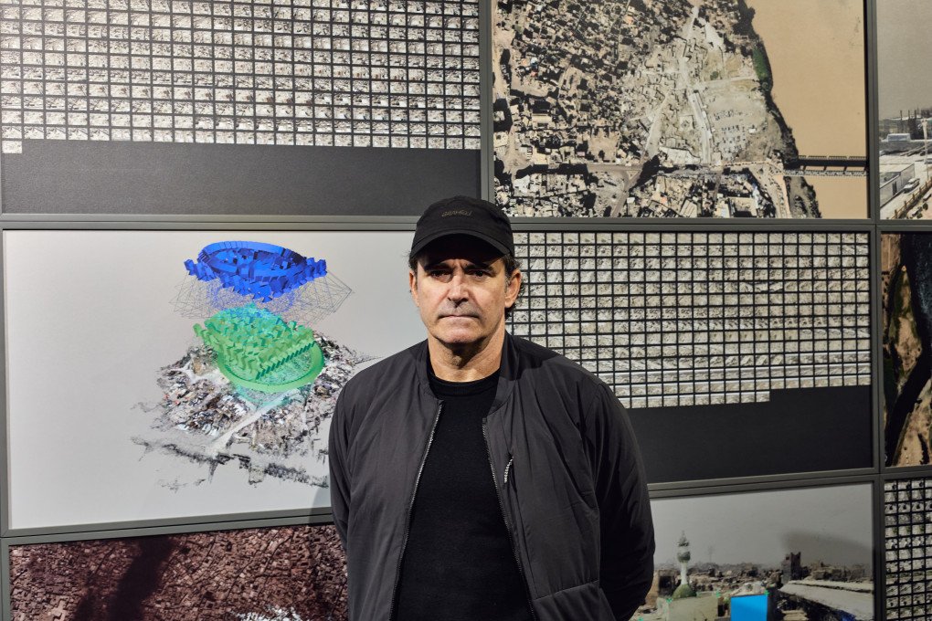 Giles Price in front of Phantom 3D, his photographic installation displayed at the IMPACT KYIV forum. Kyiv, Ukraine, October 2026 (photo: Louis Beaudemont)