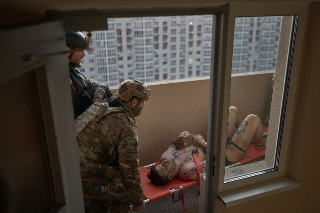 Emergency workers assist an injured man and bring him downstairs after he sustained shrapnel wounds while sitting on his balcony during an early-morning Russian drone strike on October 2, 2026 in Kyiv, Ukraine. (Photo by Kostiantyn Liberov via Getty Images)