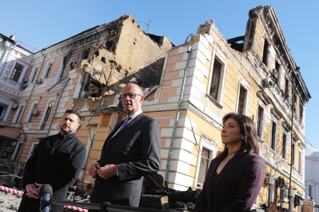 Chancellor Friedrich Merz (center, CDU), Volodymyr Zelenskyy (left), President of Ukraine, and Katherina Reiche (right, CDU), Federal Minister for Economic Affairs and Energy, stand in front of the destroyed building of the National Academy of Sciences in Kyiv, Ukraine. (Photo by Kay Nietfeld via Getty Images)