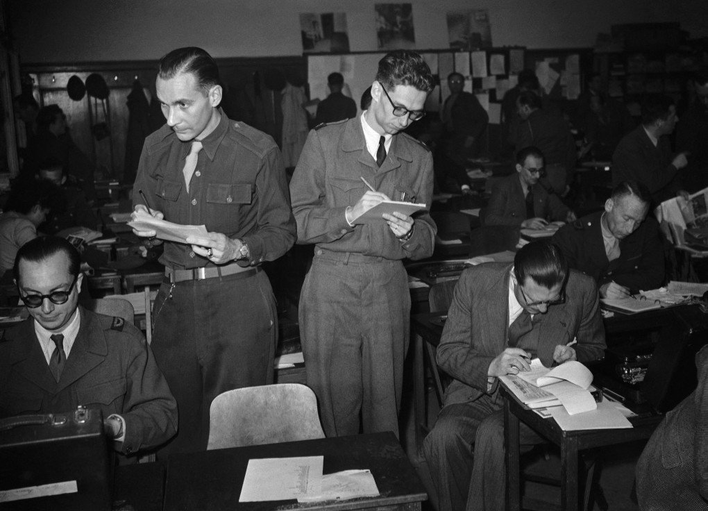Journalist Louis Deroche (L), correspondent for AFP and other journalists work on the Nuremberg trial on the day of the verdict on September 30, 1946 in Nuremberg. (Photo by AFP via Getty) Journalist Louis Deroche (L), correspondent for AFP and other journalists work on the Nuremberg trial on the day of the verdict on September 30, 1946 in Nuremberg. (Photo by AFP via Getty)