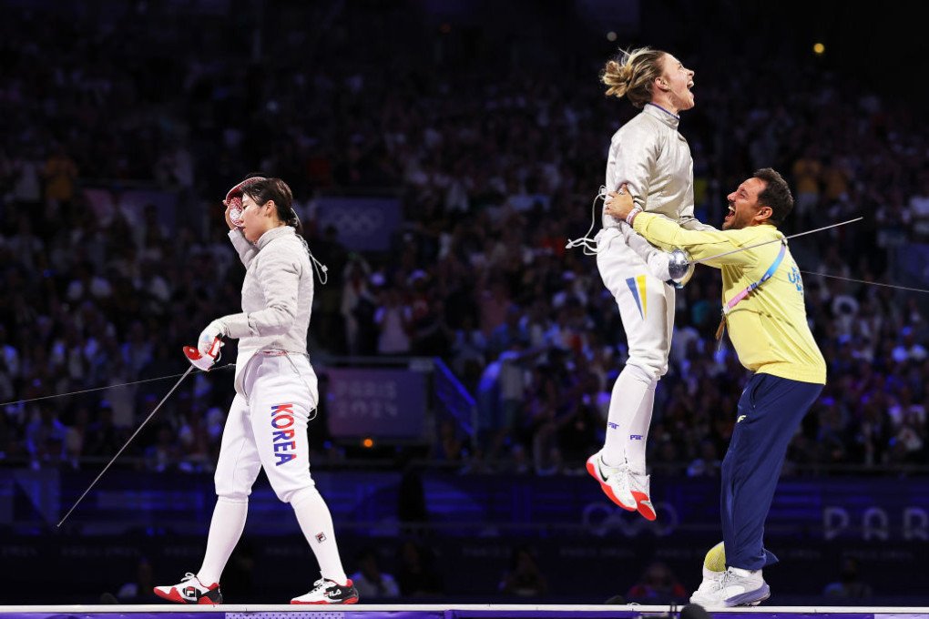 Olha Kharlan of Team Ukraine celebrates with coach following the team’s victory during the Fencing Women’s Sabre Team Gold Medal match on day eight of the Olympic Games Paris 2024 at Grand Palais on August 03, 2024 in Paris, France. (Source: Getty Images) Olha Kharlan of Team Ukraine celebrates with coach following the team’s victory during the Fencing Women’s Sabre Team Gold Medal match on day eight of the Olympic Games Paris 2024 at Grand Palais on August 03, 2024 in Paris, France. (Source: Getty Images)