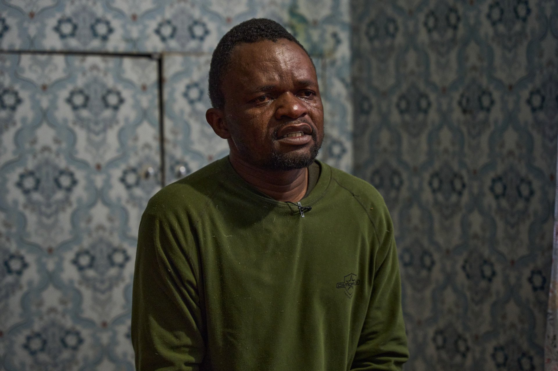 An emotional Tatenda Tarwire, a Zimbabwean prisoner of war, recounts the horrors he survived while forced to serve in the Russian military within occupied areas of Ukraine. Tarwire described enduring severe abuse from Russian commanders, witnessing thousands of corpses, and being sent on high-fatality marches that meant almost certain death. (Photo: Mykyta Shandyba / UNITED24 Media) Zimbabwean POW Tatenda Tarwire cries during an interview, visibly emotional as he describes experiencing abuse from Russian commanders and witnessing thousands of casualties while forced onto the frontlines in Russian-occupied Ukraine.