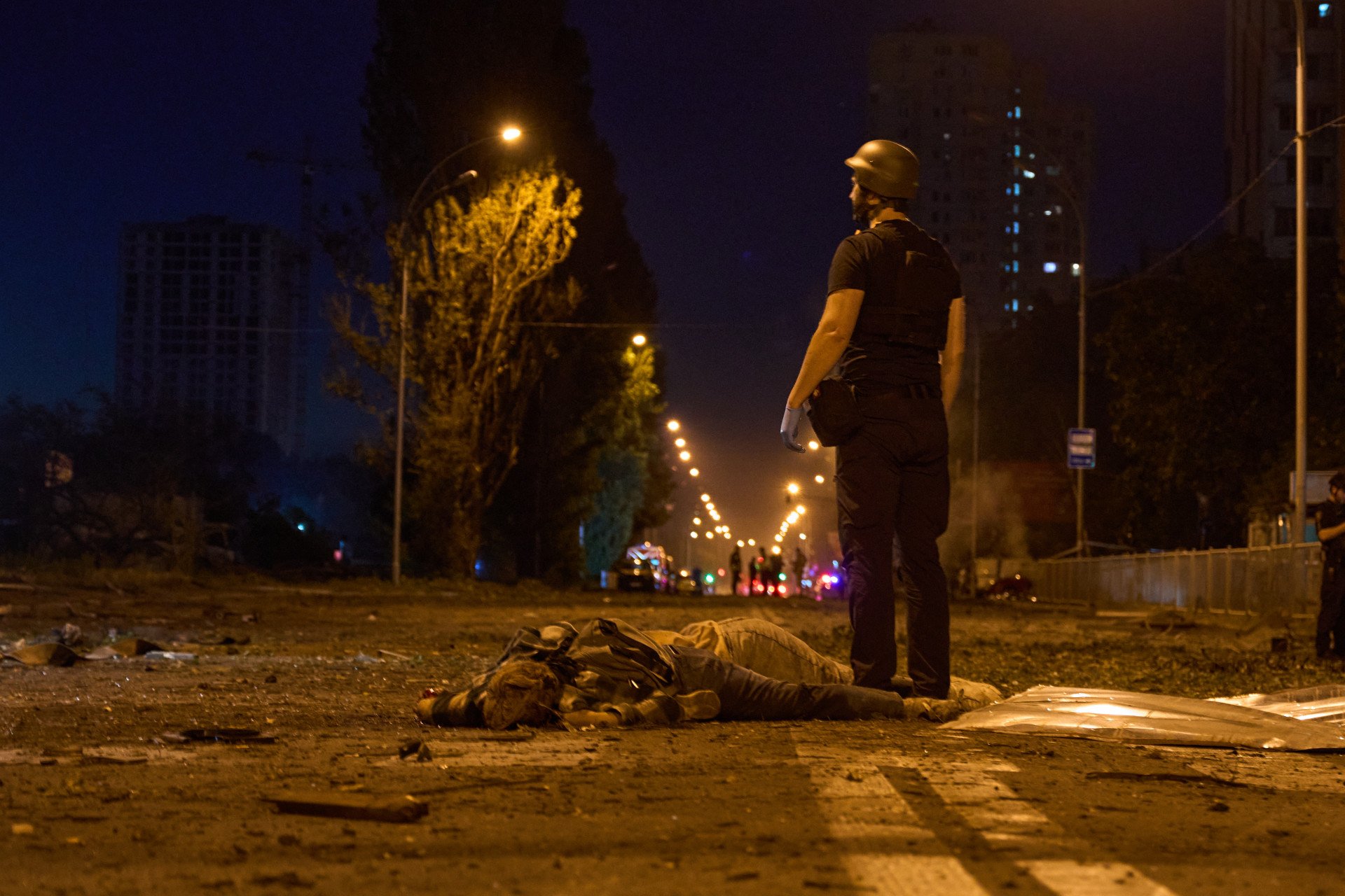 A police officer stands near the body of a victim at the site of a Russian ballistic missile strike in Kyiv. (Source: Mykyta Shandyba/UNITED24 Media) A police officer stands near the body of a victim at the site of a Russian ballistic missile strike in Kyiv. (Source: Mykyta Shandyba/UNITED24 Media)