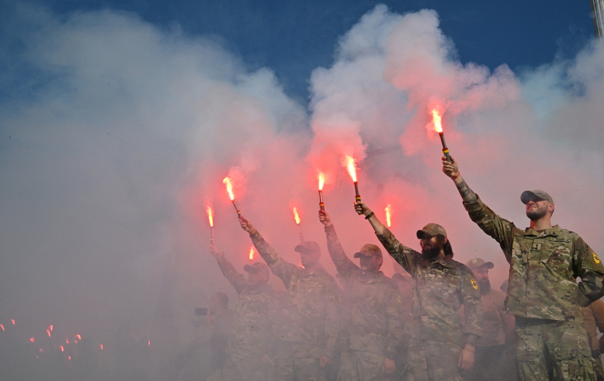 Servicemen of Ukrainian Azov Brigade burn flares during a memorial event at Independence Square