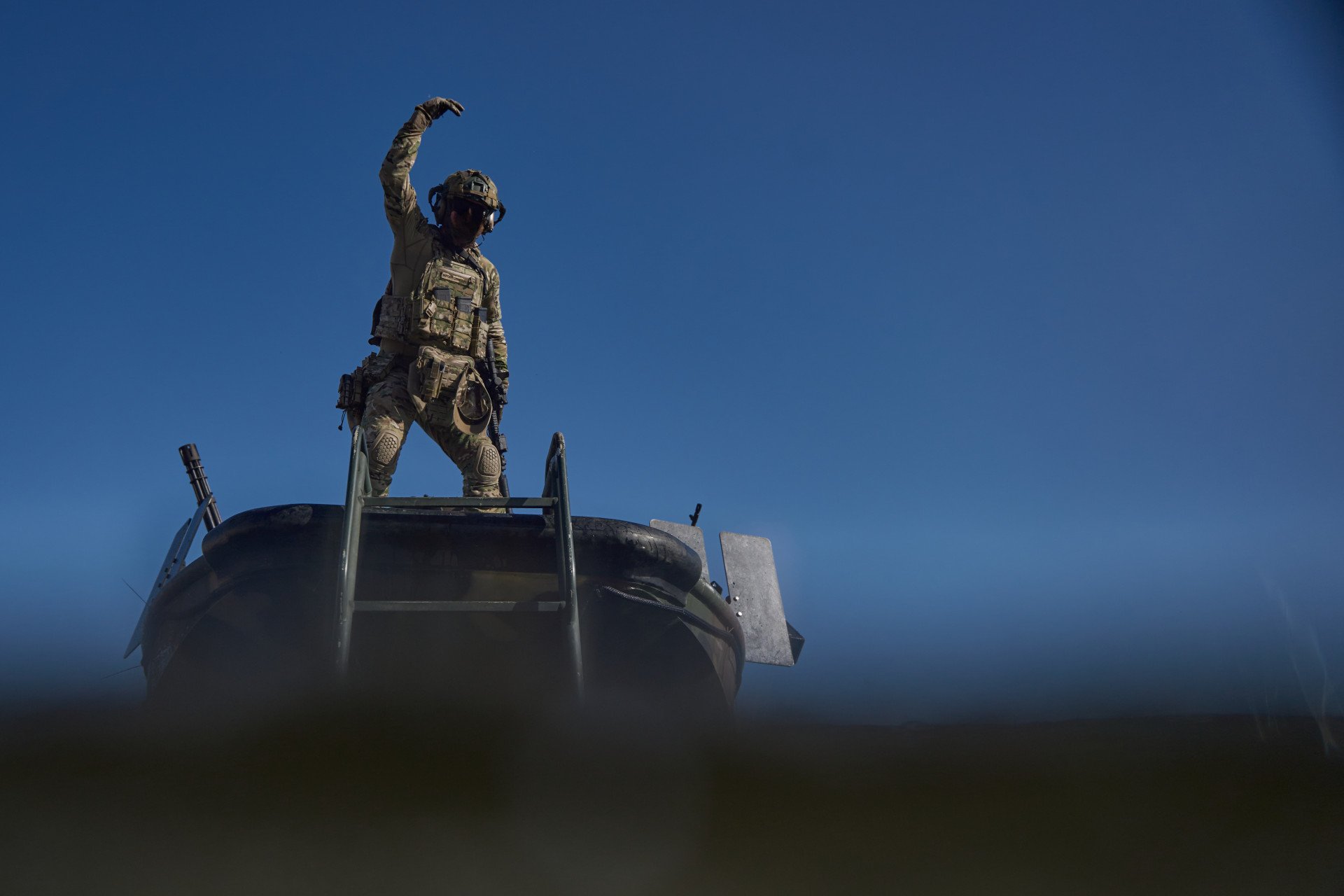At the evacuation point, a SOF crew member signals the team to board the boat. At the evacuation point, a SOF crew member signals the team to board the boat.