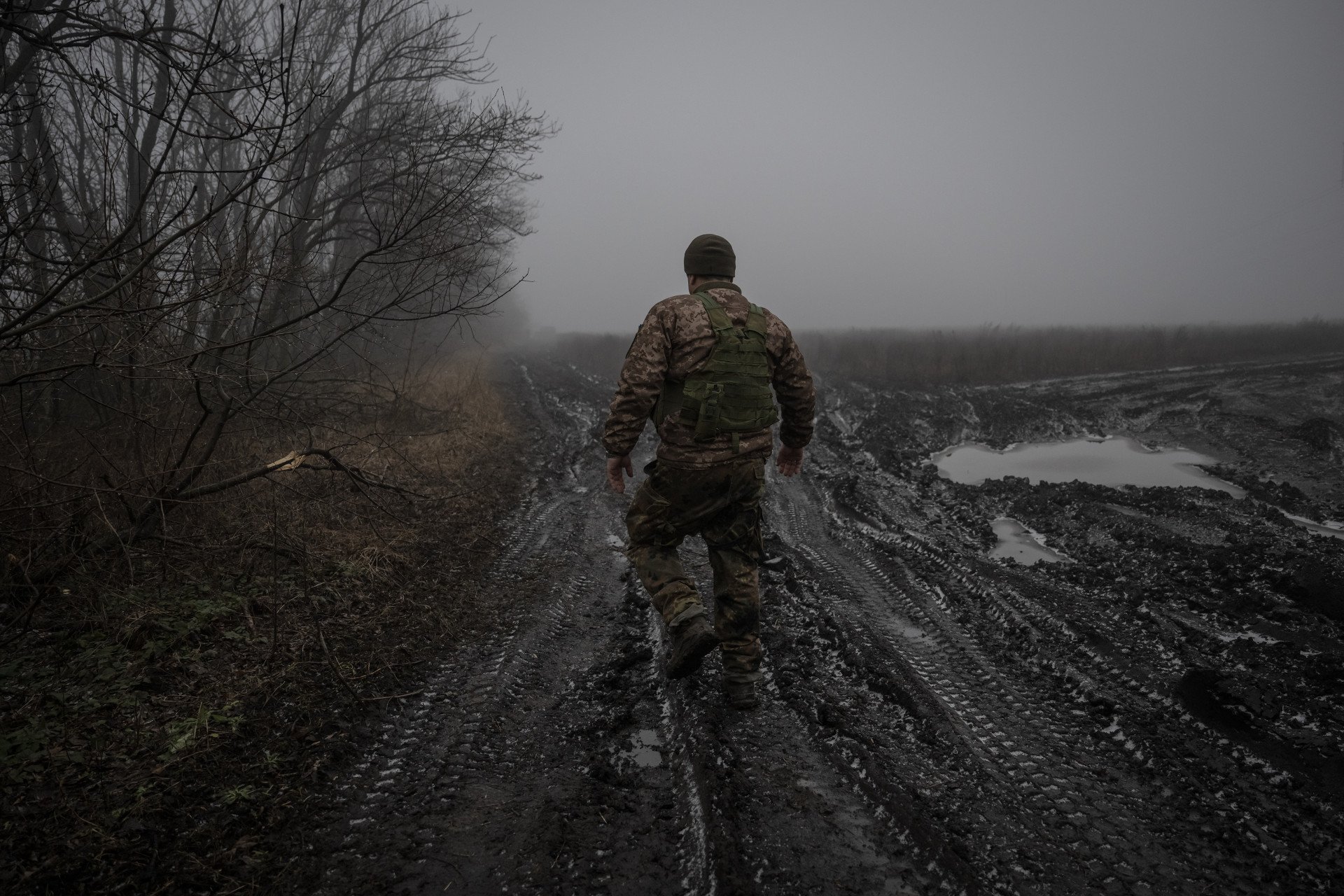 A Ukrainian soldier from an artillery unit walks along a mud-covered road toward his fighting position on the Bakhmut front line in Donetsk Oblast, Ukraine, January 4, 2024. (Photo: Ozge Elif Kizil/Anadolu via Getty Images) How cold is it in Ukraine?