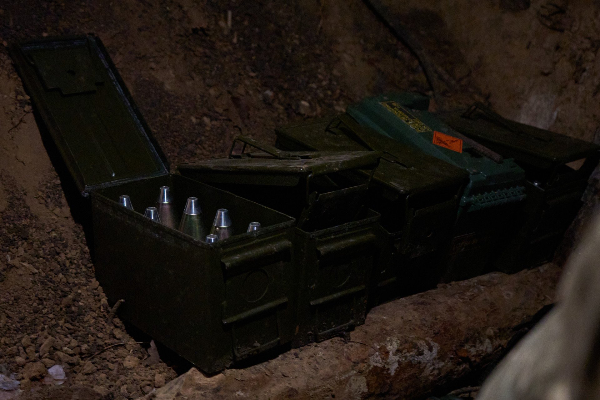 Cases of artillery shells are stockpiled in dark excavations hidden by camouflage nets. The commander jokingly warns the team not to smoke inside, or we’ll do the job of the Russians for them. These shells are highly valuable as the Ukrainian military is critically short of shells. The team has to use the ones they have sparingly and accurately as Western help threatens to dwindle over winter. Each shell counts when calculating the crew’s chance of survival to see victory. 