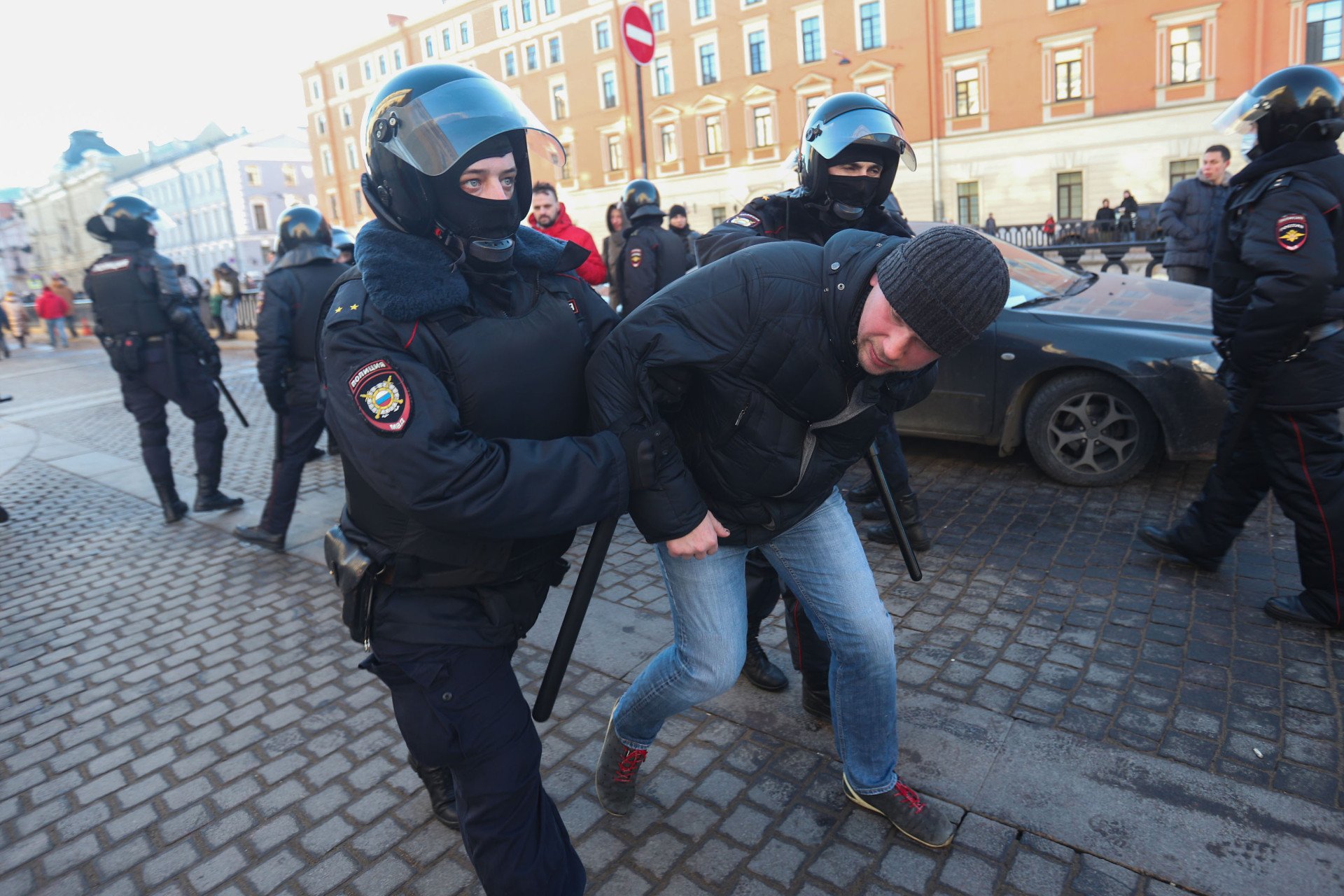 Police Officers detain a protestor during a demonstration against the Russian military operation in Ukraine.