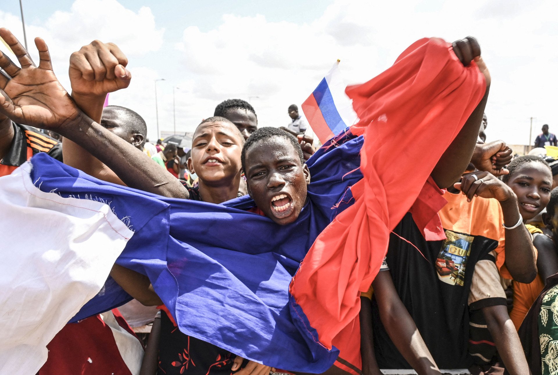 A man is covered with a Russian flag as supporters of the Niger's National Council for the Safeguard of the Homeland (CNSP) gather to demonstrate ouside the Niger and French airbases in Niamey on August 27, 2023.(Photo by AFP via Getty Images) A man is covered with a Russian flag as supporters of the Niger's National Council for the Safeguard of the Homeland (CNSP) gather to demonstrate ouside the Niger and French airbases in Niamey on August 27, 2023.(Photo by AFP via Getty Images)