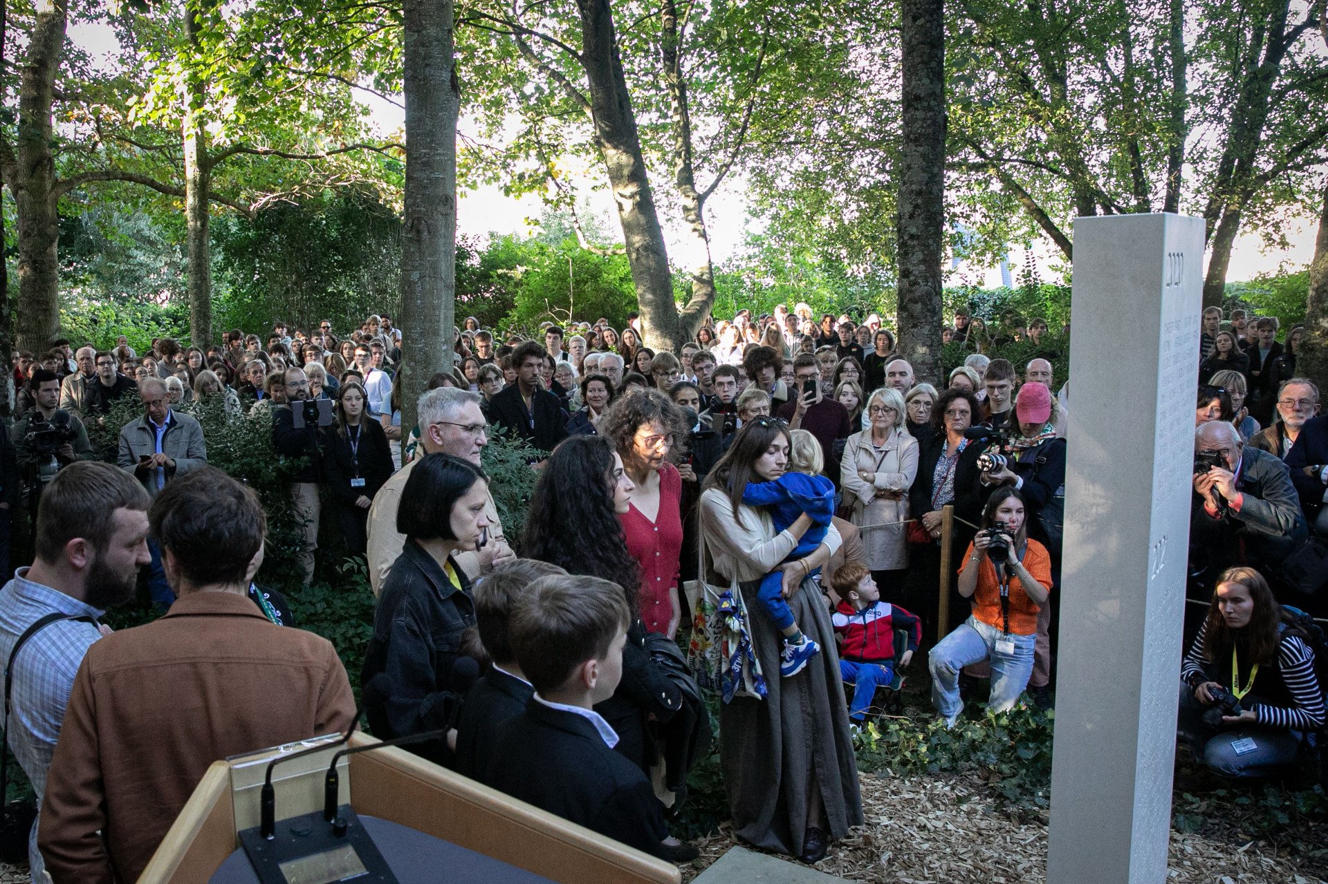 Relatives of late journalists and visitors gather at the Reporters Memorial in Bayeux, France, during the 29th Bayeux Calvados-Normandy Awards, to honor journalists killed in 2022. (Photo: Getty Images)