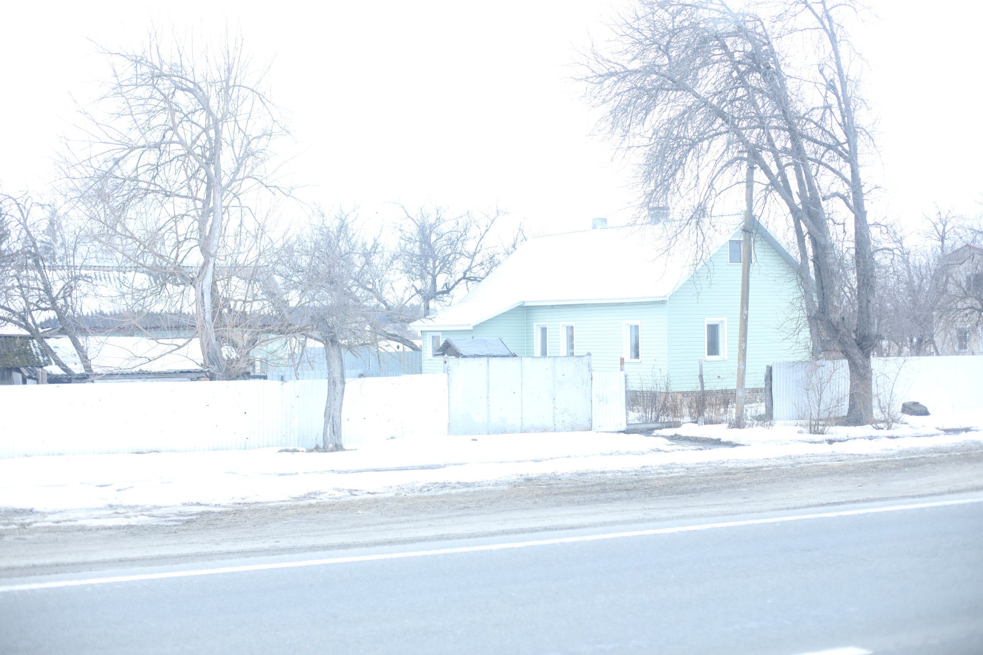 A house in Yahidne, its gates still marked by gunshots. Residents tend to their summer gardens, many with a view of the school where they were imprisoned for nearly a month. (Photo: Lucile Brizard)
