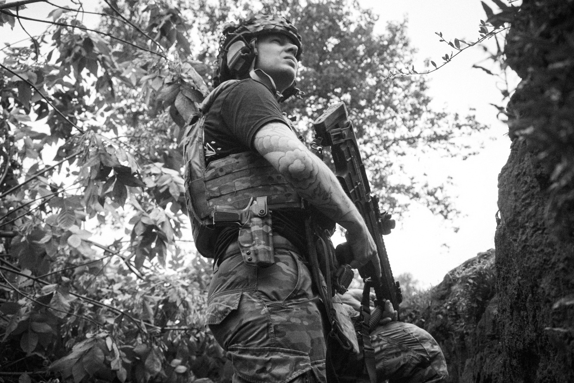 Yevhen, from the 28th Brigade, spotting a FPV drone while holding a Ukrainian-made semi-automatic 12-gauge shotgun. Kostiantynivka, August 2025. Photo: Josh Olley/UNITED24 Media