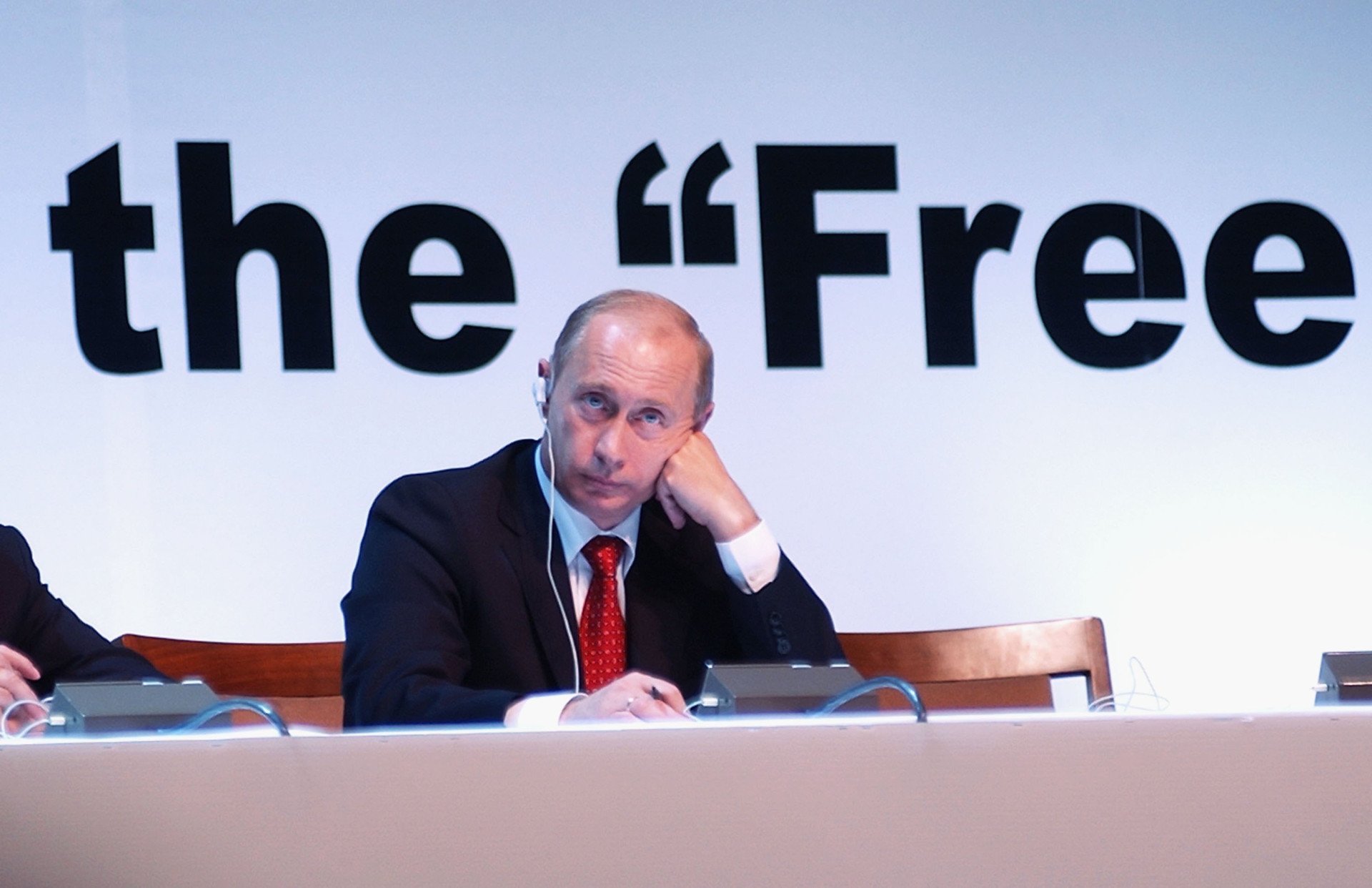 Putin, rests his head on his hand as he listens to calls from the world's publishers for a free and independent press in Russia