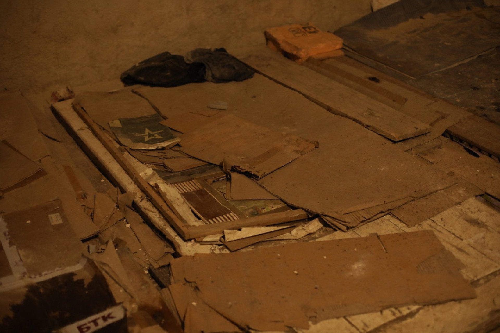 Cardboard boxes and Russian military food rations were used by the inhabitants of Yahidne as makeshift mattresses, with the 368 occupants each occupying an area no larger than a chair. (Photo: Lucile Brizard)