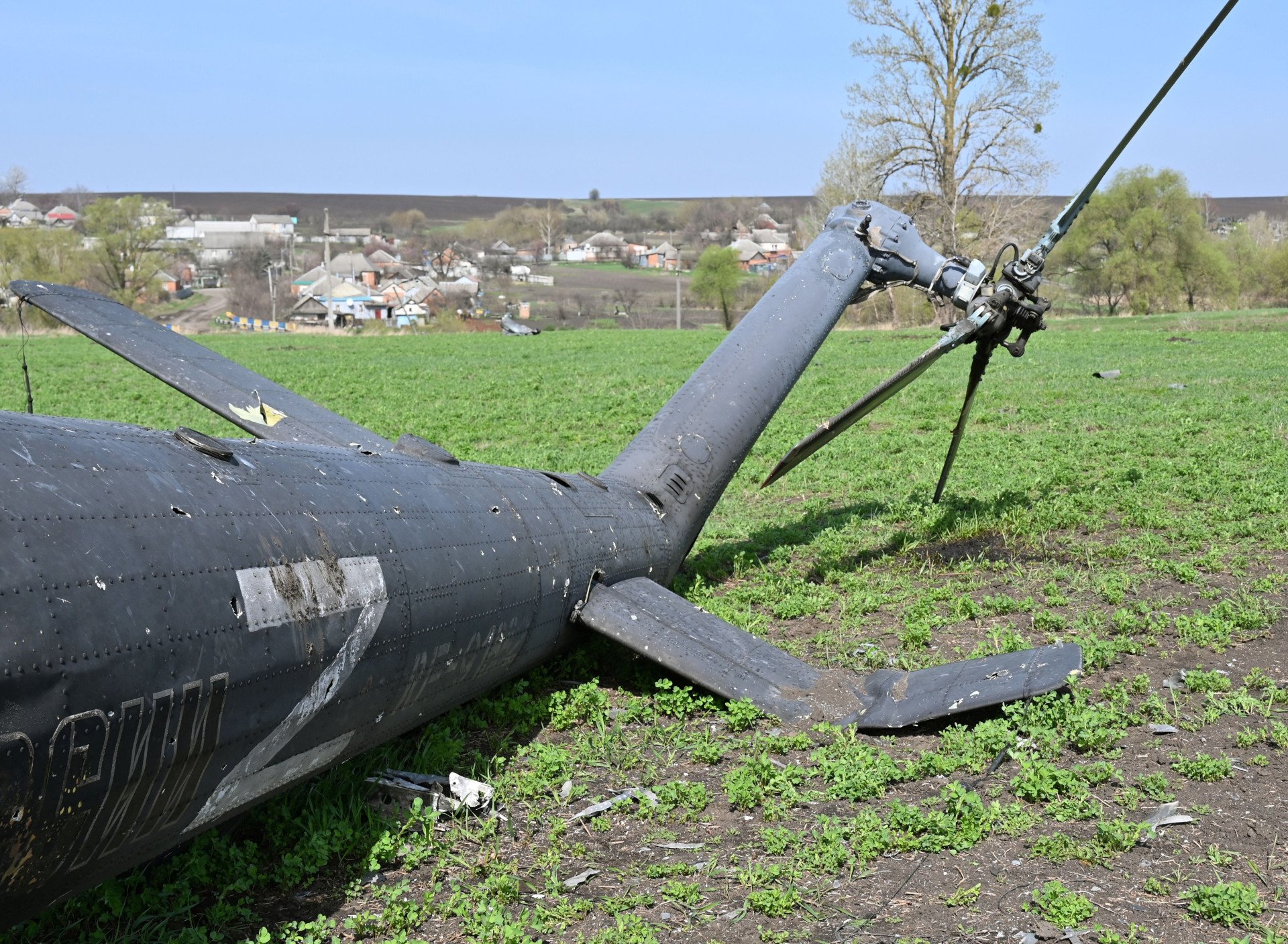 The wreckage of a downed Russian helicopter lies in a field near Kharkiv on April 16, 2022