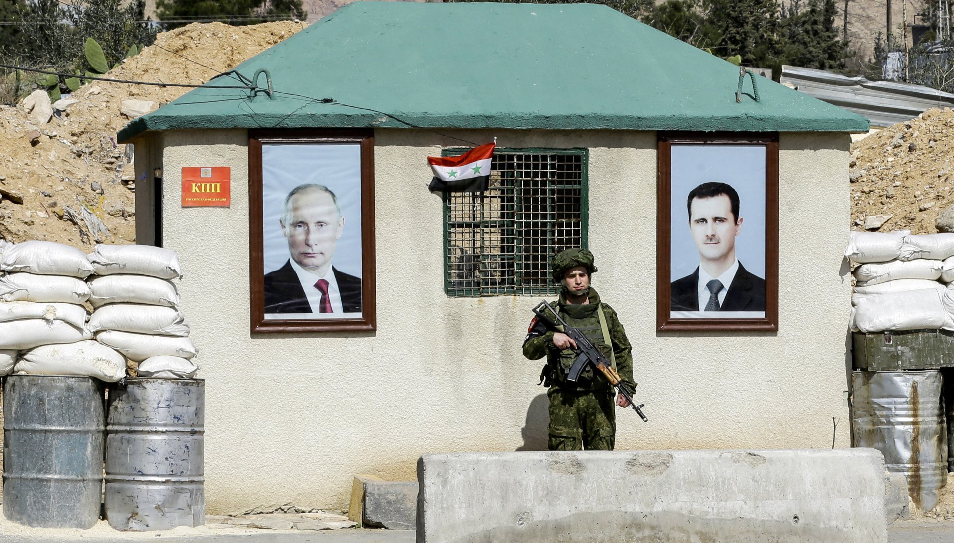 a member of the Russian military police standing guard on the outskirts of Damascus