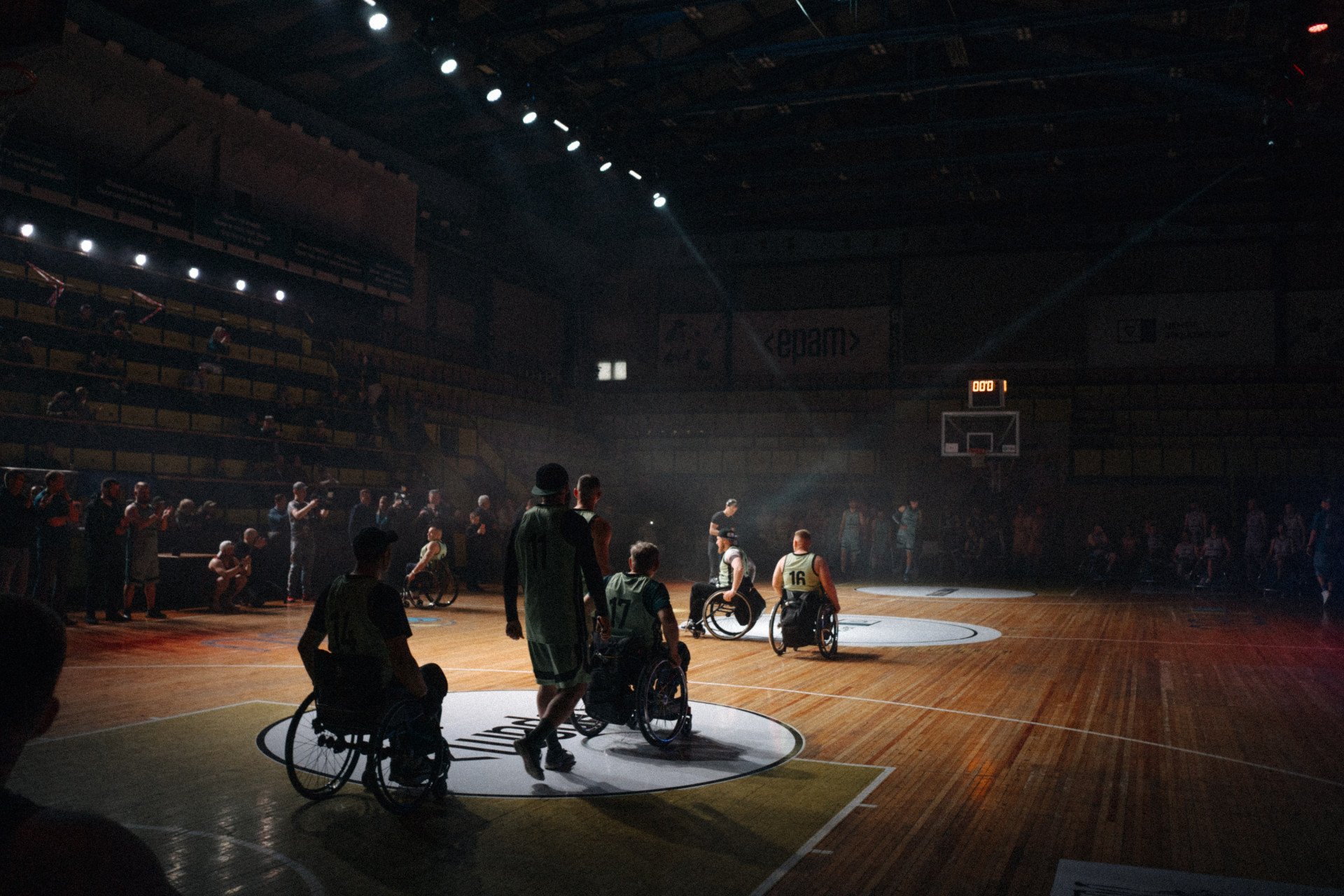 Teams gather at center court after scoring final points to win the championship at All-Ukrainian Wheelchair Basketball Tournament for veterans. Photo: Tim Pushkaruk, Come Back Alive Foundation Teams gather at center court after scoring final points to win the championship at All-Ukrainian Wheelchair Basketball Tournament for veterans. Photo: Tim Pushkaruk, Come Back Alive Foundation