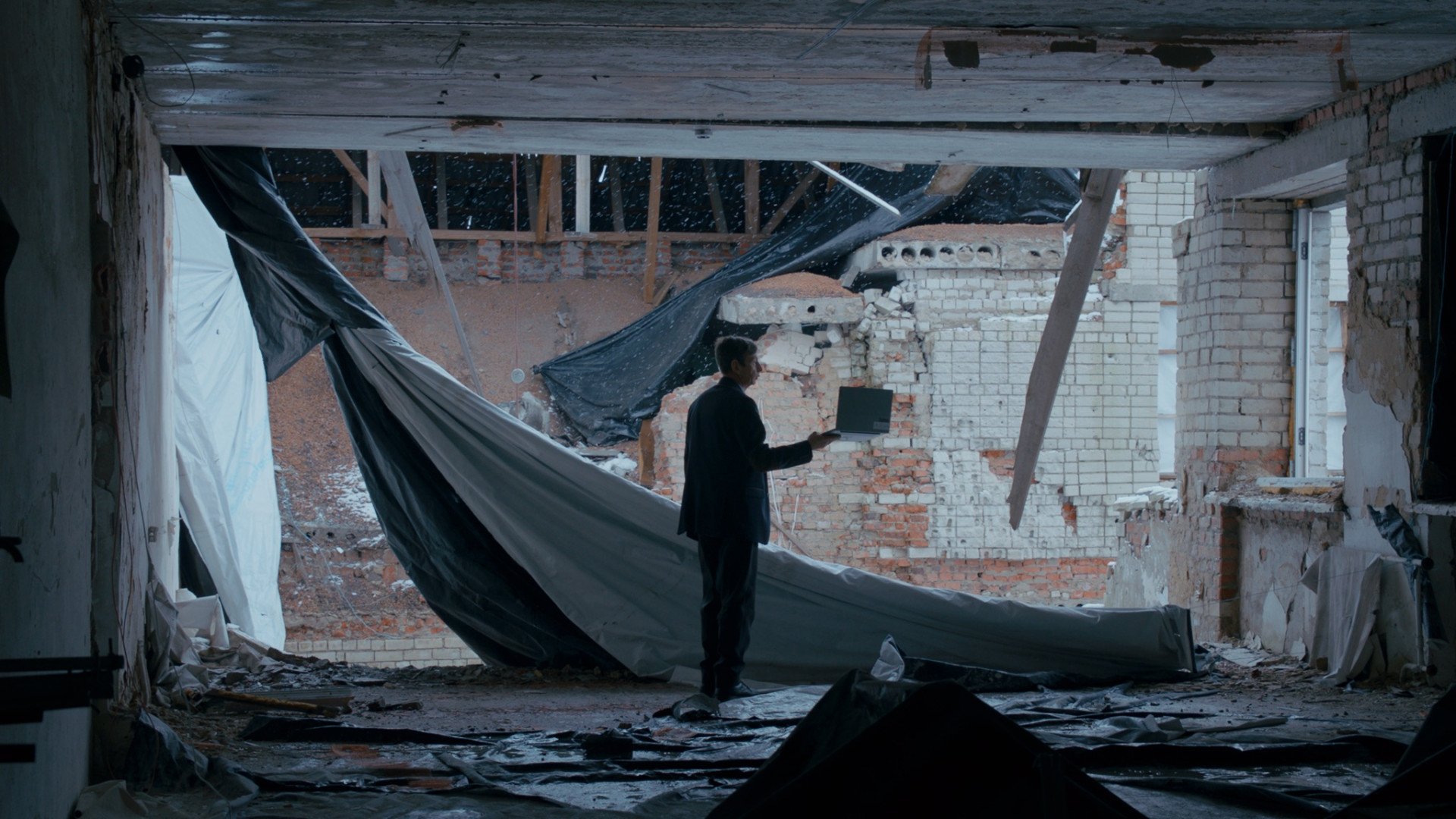 A headmaster shows a journalist the damage to his school, hit by a Russian missile, in a scene from Timestamp. Gornostai recreated the moment, as the headmaster had done the same for her when they first spoke. (Source: 2Brave Productions)