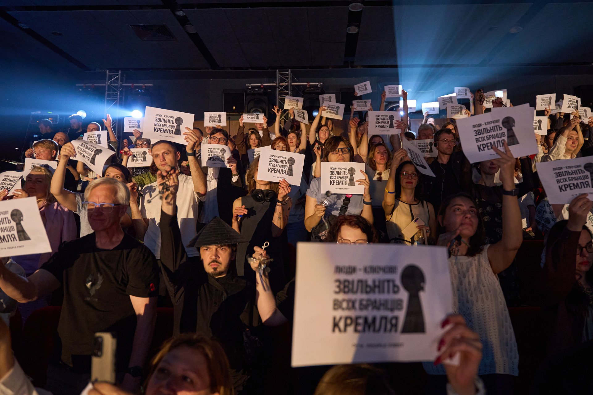 Opening of the 23rd Docudays UA International Human Rights Documentary Film Festival, in Kyiv, Ukraine. The spectators wave keys and a sign reading “Free all the Kremlin’s captives” in honor of the civilians and soldiers still imprisoned by Russia.(Photo: Mykyta Shandiba/UNITED24 Media)
