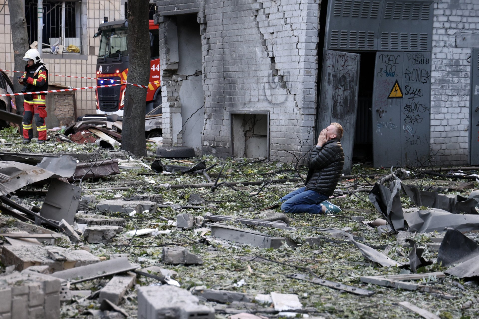 Ukrainian civilians are seen as emergency teams start working in the area following Russian forces launched a combined attack involving cruise missiles, ballistic missiles, and strike UAVs overnight in Kyiv. (Photo by Kyiv Mil. Adm. / Ivan Antypenko / Handout /Anadolu via Getty Images)