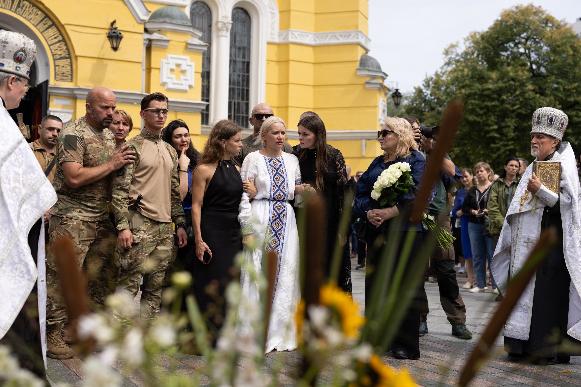 Oleksii Yukov’s wife, Yevhenia Kaluhina, his daughter Daria, colleagues, and friends, during the farewell ceremony in Kyiv, Ukraine, August 8, 2026. Oleksii Yukov is the head of the “Platsdarm” search group, which is engaged in the search for dead and missing military personnel. Photo by Vic Bakin Oleksii Yukov’s wife, Yevhenia Kaluhina, his daughter Daria, colleagues, and friends, during the farewell ceremony in Kyiv, Ukraine, August 8, 2026. Oleksii Yukov is the head of the “Platsdarm” search group, which is engaged in the search for dead and missing military personnel. Photo by Vic Bakin