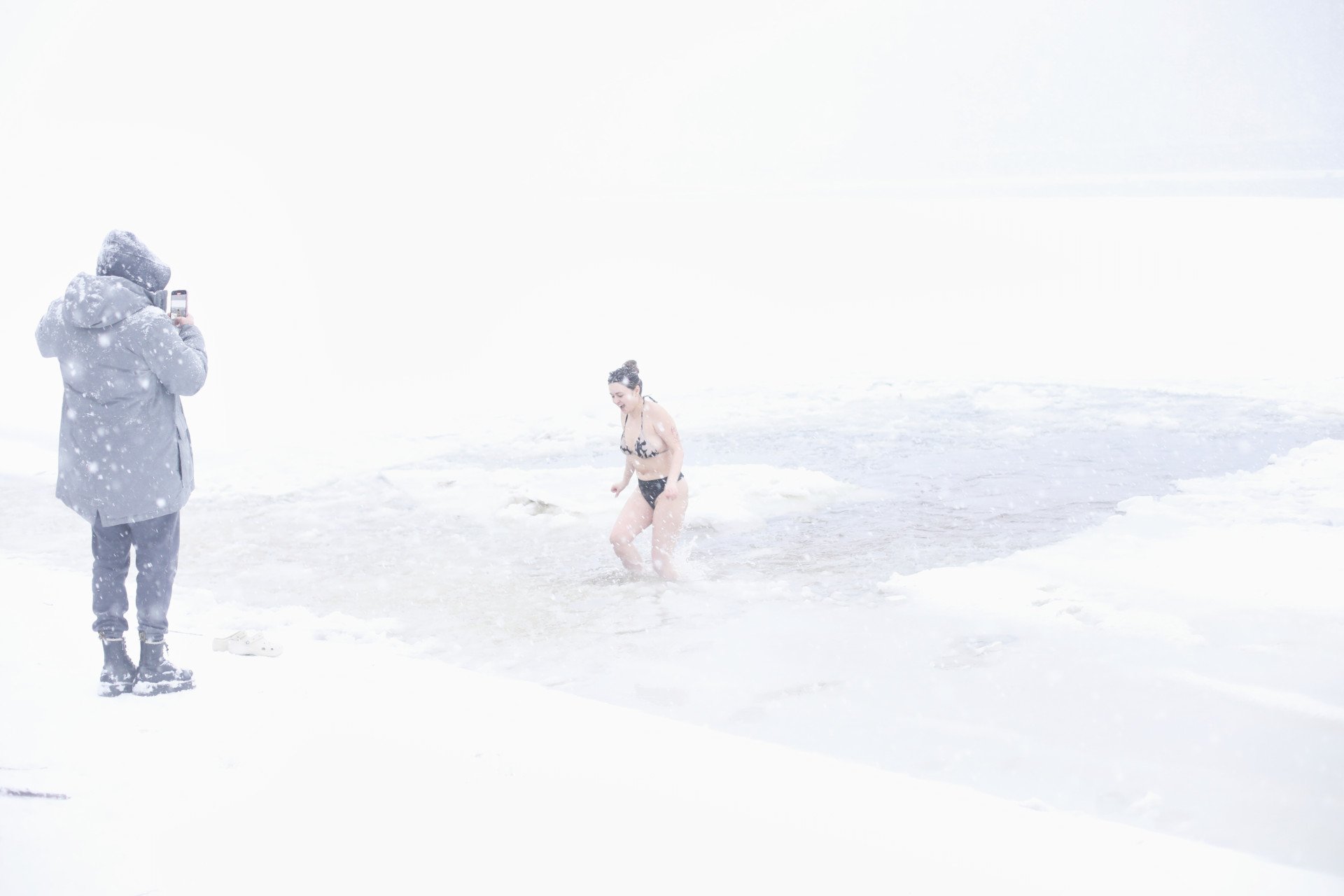 A young woman exits the Dnipro on Trukhaniv Island. Kyiv, Ukraine, January 6, 2026. (Photo: Lucile Brizard) A young woman exits the Dnipro on Trukhaniv Island. Kyiv, Ukraine, January 6, 2026. (Photo: Lucile Brizard)