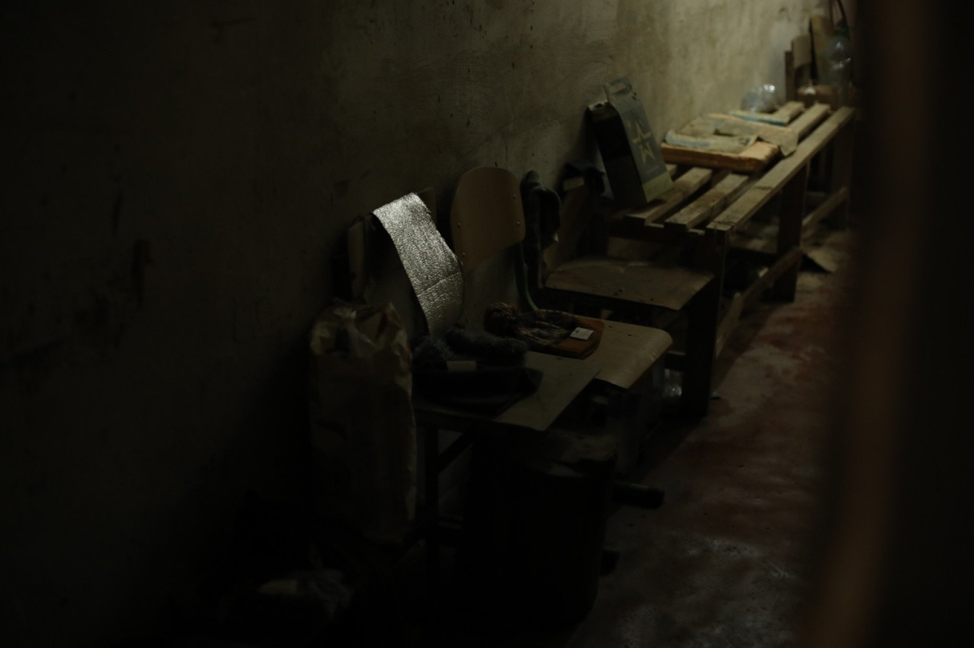 The hallway of the basement in Yahidne, where people sat from March 3 to March 30, 2022, they were used as human shields, with Russian soldiers establishing a makeshift military position above the cramped space. (Photo: Lucile Brizard)