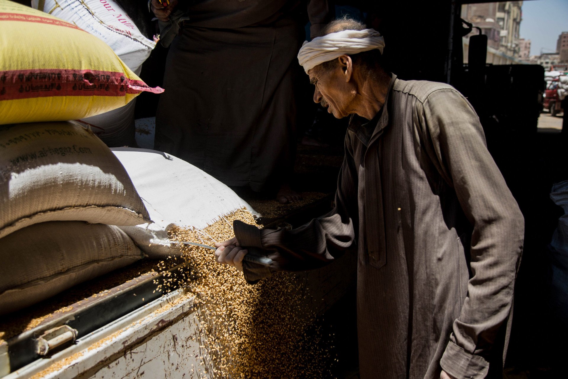 A worker uses a sickle to cut a sack of delivered wheat grain at a government-operated mill in central Fayoum, Egypt, on Thursday, May 19, 2022. One of the world's biggest wheat importers, Egypt is wrestling with the impact of Russias invasion on Ukraine on supplies. (Photographer: Islam Safwat via Getty Images) A worker uses a sickle to cut a sack of delivered wheat grain at a government-operated mill in central Fayoum, Egypt, on Thursday, May 19, 2022. One of the world's biggest wheat importers, Egypt is wrestling with the impact of Russias invasion on Ukraine on supplies. (Photographer: Islam Safwat via Getty Images)