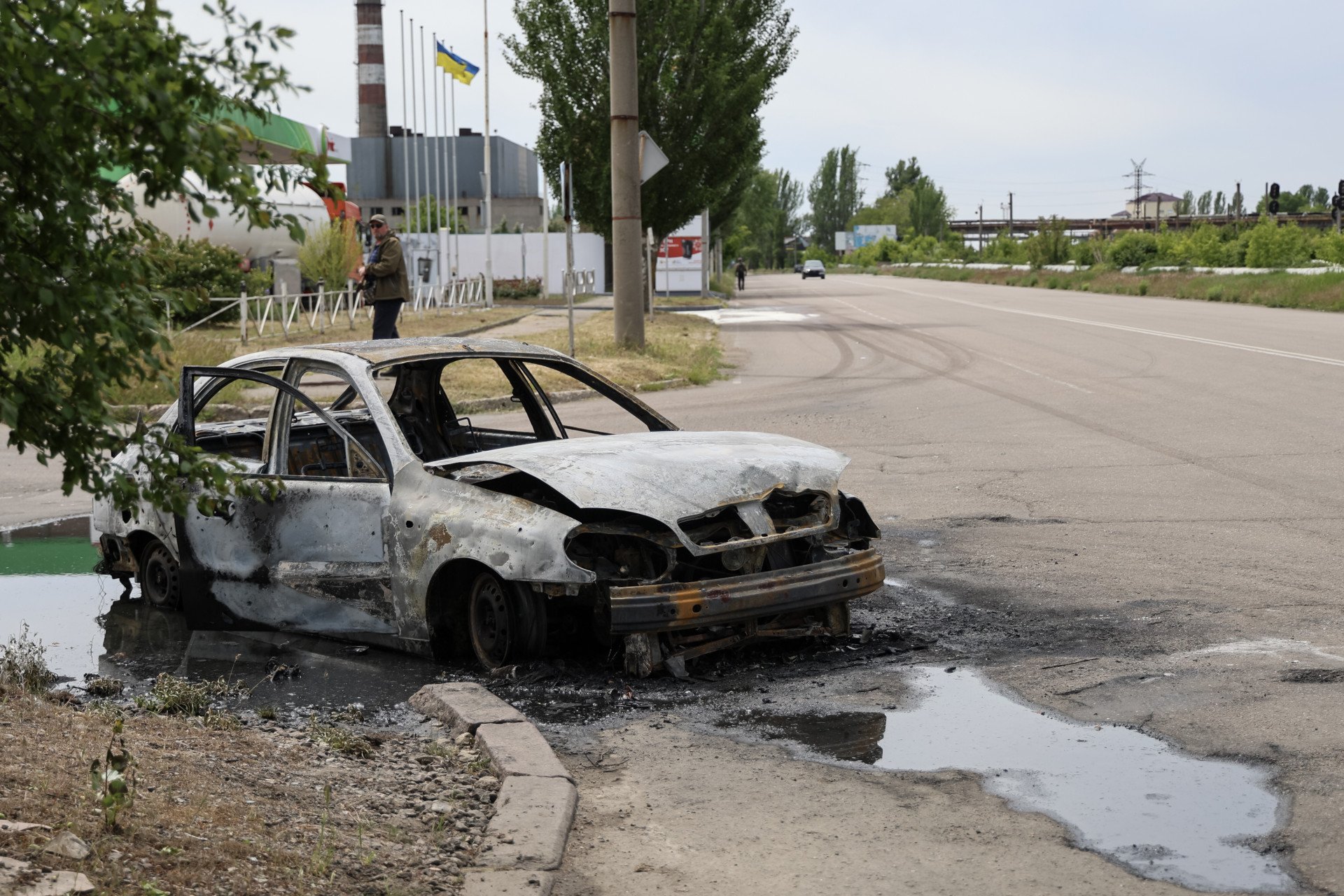 A car wreckage destroyed by Russian drone attack remains on the Beryslavske highway (a man and a woman were injured by the explosives, who were leaving the gas station at the time of the drone strike) on May 16, 2025 in Kherson, Ukraine. Photo by Ivan Antypenko/Suspilne Ukraine/JSC “UA: PBC"/Global Images Ukraine via Getty Images.