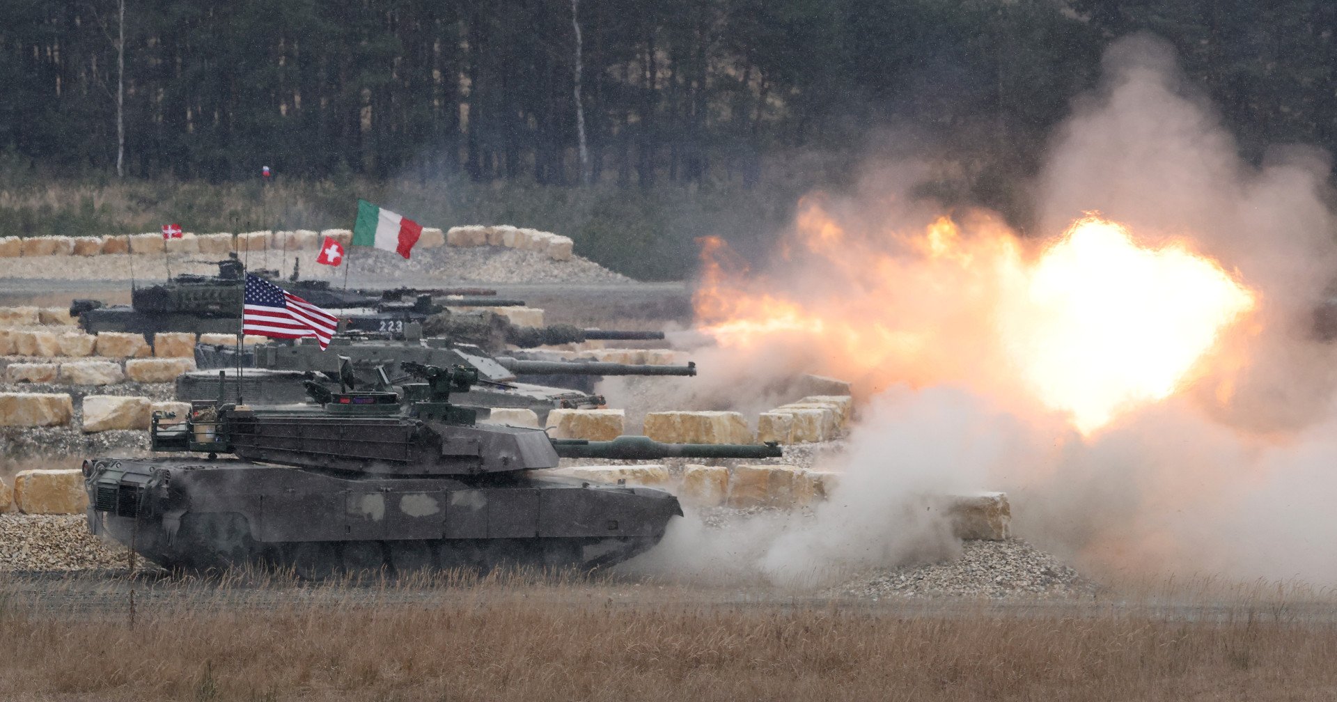 Main battle tanks from different countries, including the United States, Italy, Switzerland, and Denmark, fire a volley during the US Army Europe and Africa International Tank Challenge on February 11, 2025, at Grafenwoehr, Germany. (Source: Getty Images)